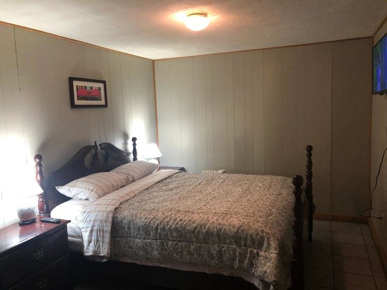 Suite bedroom with a four-poster bed
